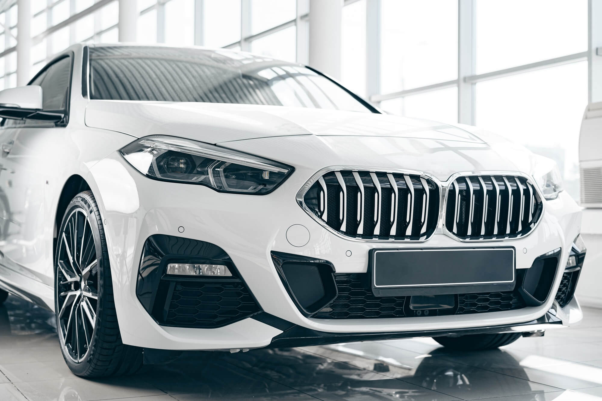White luxury passenger car standing inside salon