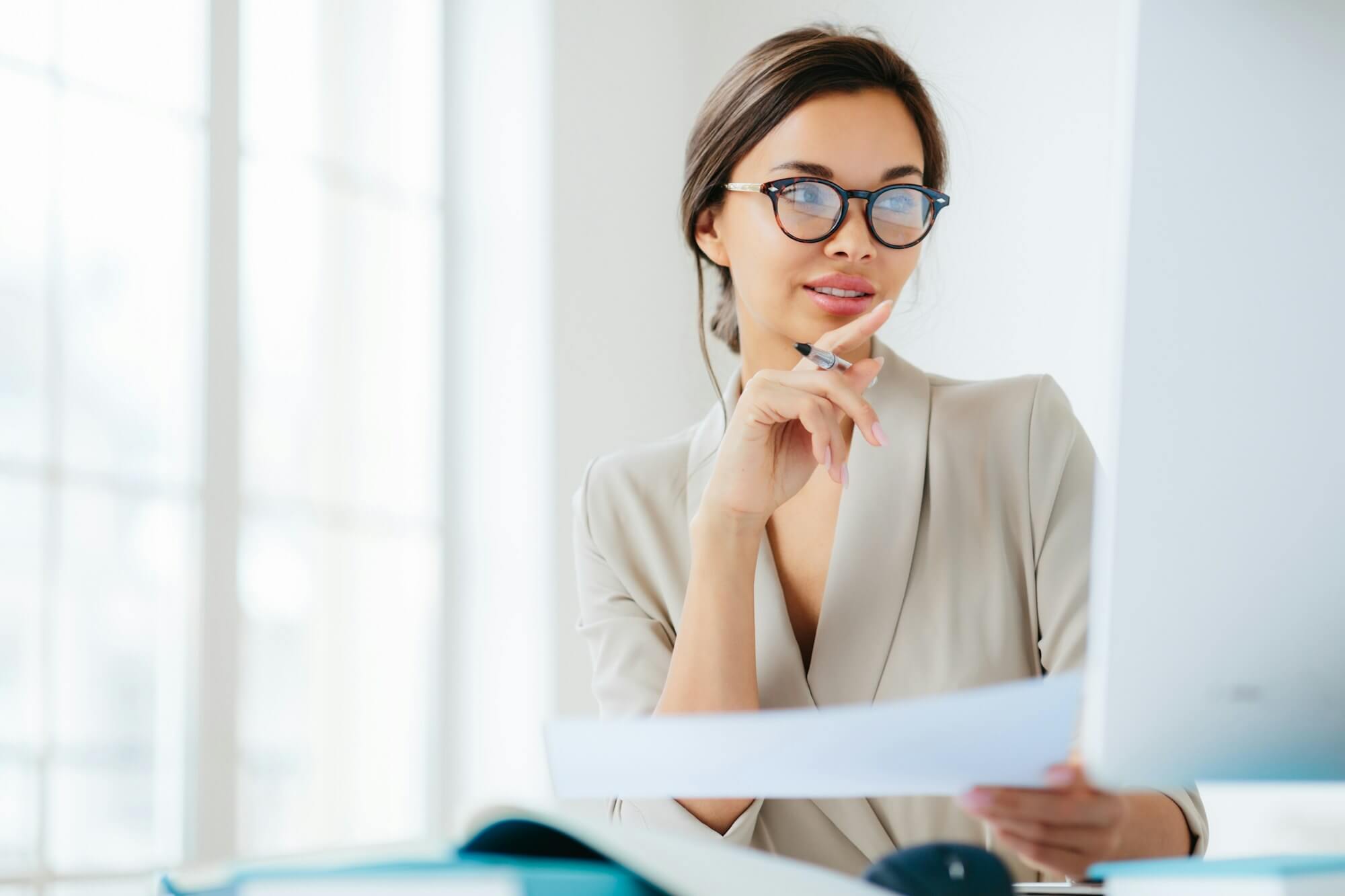 economist poses in coworking space, focused in monitor, verifies or checks figures