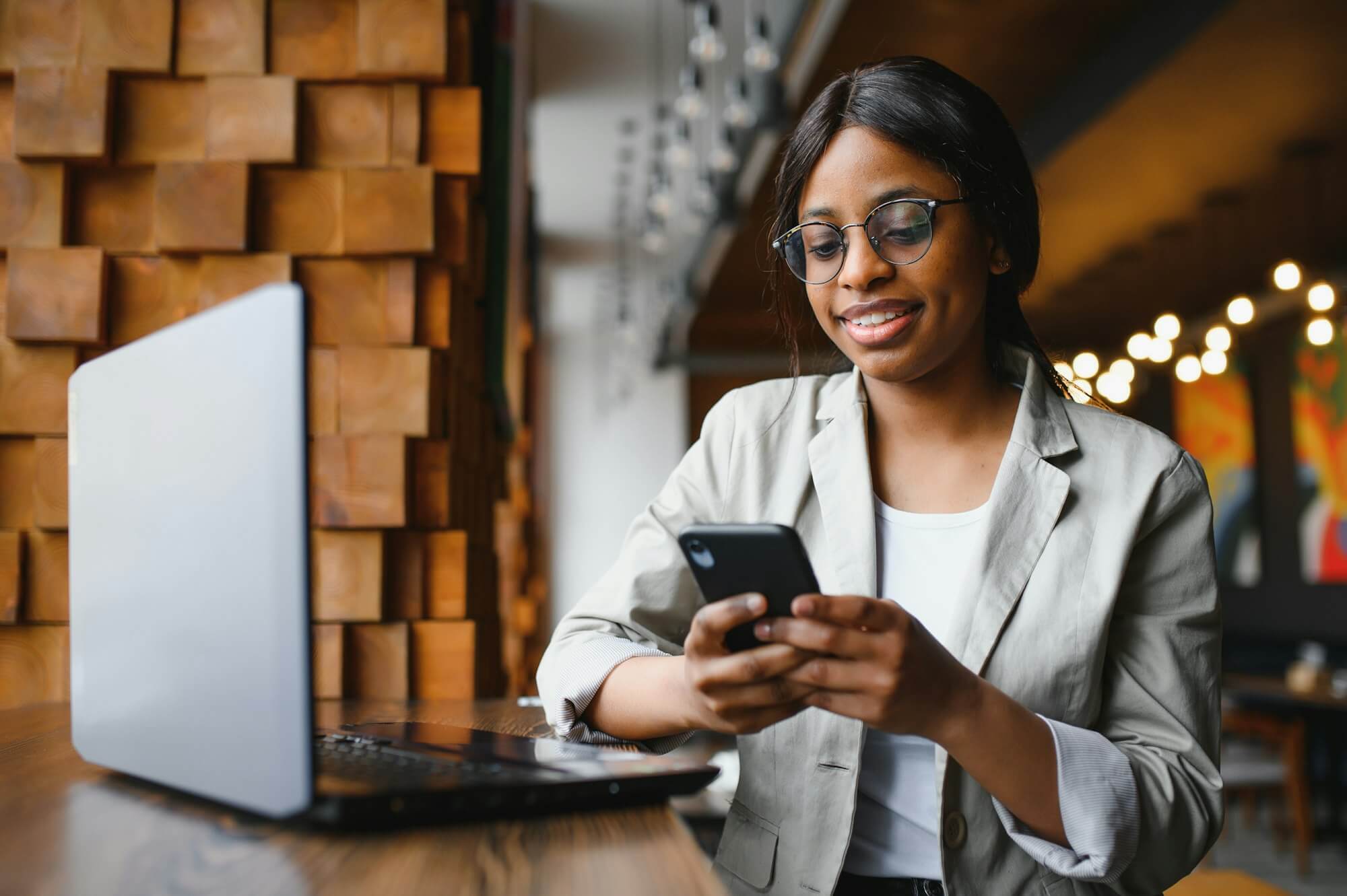 Young business woman is arranging the next business meeting in a modern coworking space