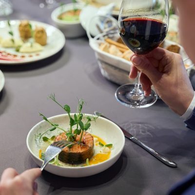 unrecognizable-man-holding-glass-of-wine-having